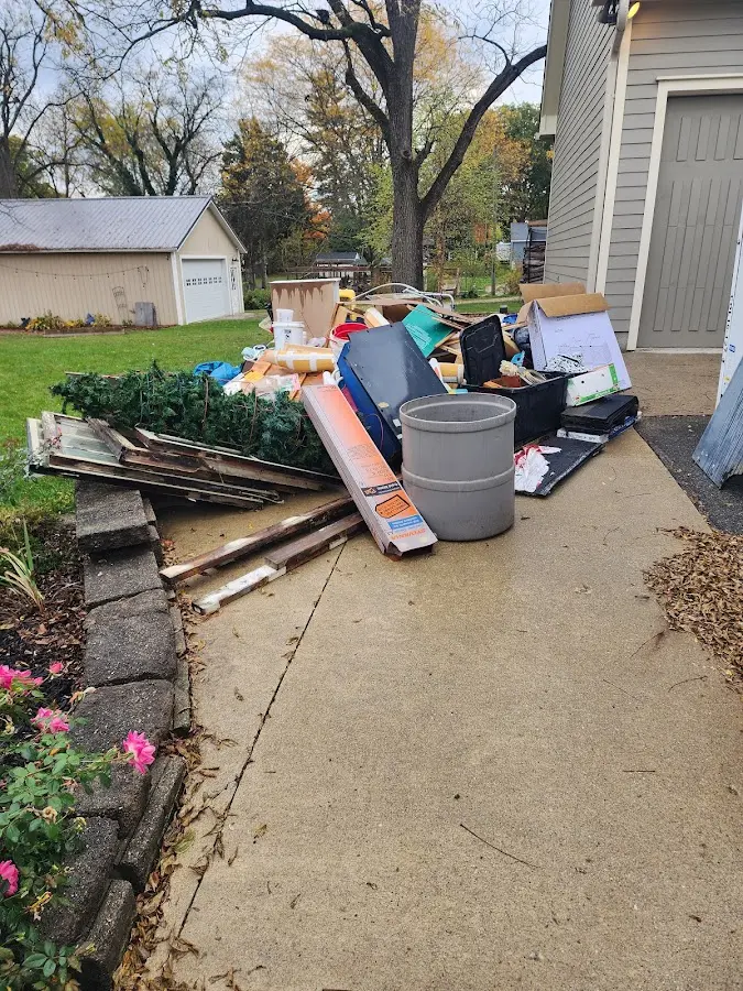 Dumpster being loaded with debris for 12 Yard Dumpster Rental in Kendall West